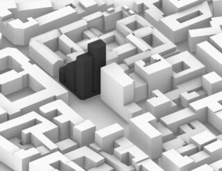 3D-Darstellung eines Häuserblocks mit einer Ansammlung schwarzer Gebäude in der Mitte, umgeben von weißen Gebäuden unterschiedlicher Höhe.