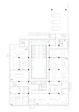 Architektonischer Grundriss eines Gebäudes mit Zimmern, Büros, Besprechungsbereichen, Möbelanordnung, zentralem Atrium und Außenparkplätzen oben rechts.