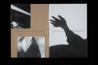 Offenes Buch mit abstrakten Schwarzweißfotografien; auf der linken Seite sind zwei unscharfe Bilder zu sehen, auf der rechten Seite ist der Schatten einer ausgestreckten Hand zu sehen.