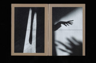 Auf einer Doppelseite sind zwei Schwarzweißfotos zu sehen: Das linke zeigt den Schatten eines langen Arms, das rechte eine Hand, die einen deutlichen Schatten auf eine strukturierte Wand wirft.