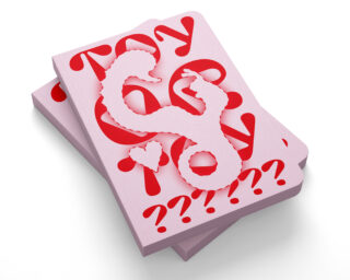 Auf einer weißen Oberfläche sind zwei rosa Karten mit roten Fragezeichen und skurrilen Buchstaben gestapelt, die oben mit einer ausgeschnittenen Drachenauflage versehen sind.