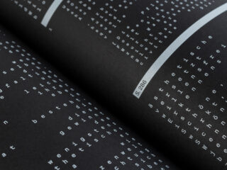 Nahaufnahme eines Buches mit Seiten mit weißem, vertikal ausgerichtetem deutschem Text auf schwarzem Hintergrund und einem Etikett mit der Aufschrift „S. 286.“.