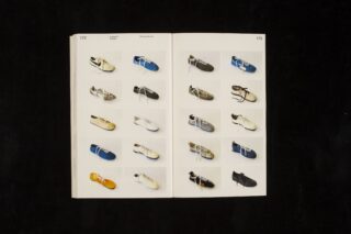 Ein offenes Buch mit zwölf Paar Schuhen, die in Reihen auf zwei Seiten angeordnet sind. Jedes Paar ist von oben vor einem weißen Hintergrund fotografiert.