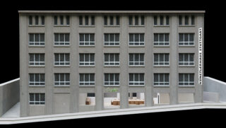 Vorderansicht eines grauen rechteckigen Gebäudes mit der Aufschrift „Künstlerhaus Stuttgart“ mit mehreren Fenstern und einem offenen Cafébereich im Erdgeschoss.