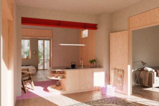 Moderne, offen gestaltete Wohnung mit hellen Holzoberflächen, einer kleinen Küche, offenem Schlaf- und Wohnbereich, rosa Fliesenboden, Wandregalen und Tageslicht durch große Fenster.