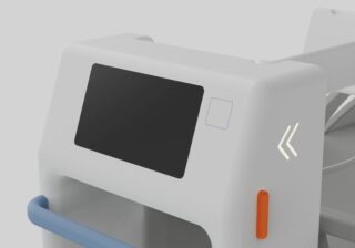Nahaufnahme eines weißen elektronischen Geräts mit einem großen schwarzen Bildschirm, einem orangefarbenen Knopf, einem blauen Griff und zwei weißen Pfeilsymbolen an der Seite.